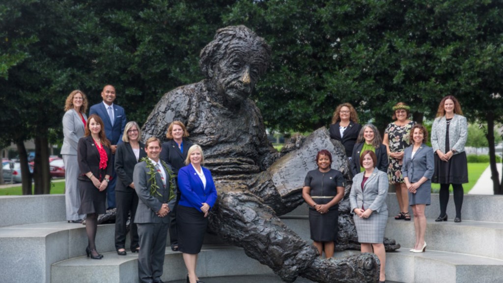 shawn sheehan and the other fellows stand by a statue of albert einstein 