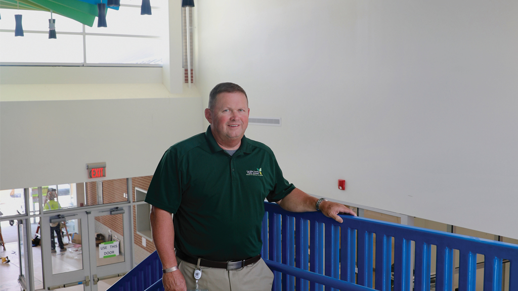 Milton Nagel, former assistant superintendent for administrative services for m Maryland’s Caroline  County Public Schools, poses for a picture at the top of a school stairway