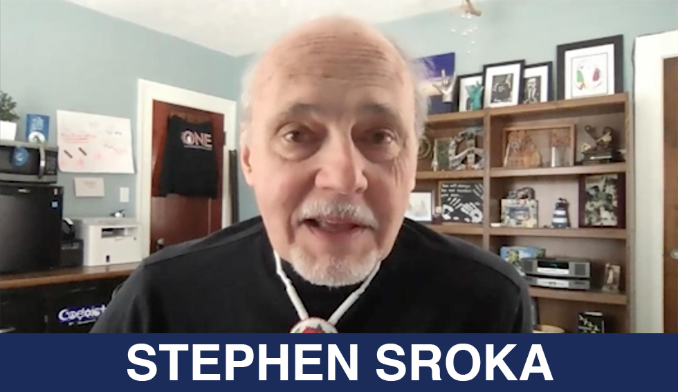 Stephen Sroka smiles at the camera. the text reads "Stephen Sroka"