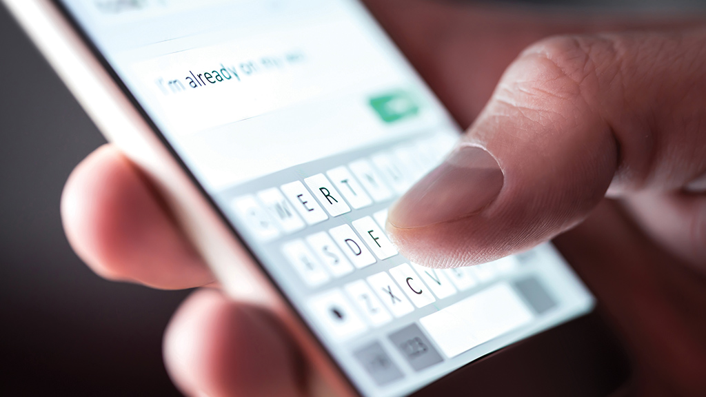 a close up of a person typing a message on a phone
