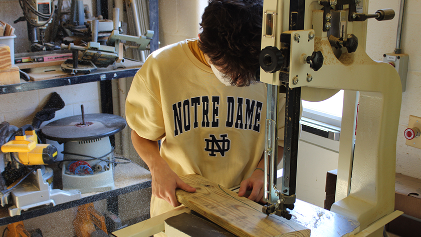 A student uses a woodcutting machine