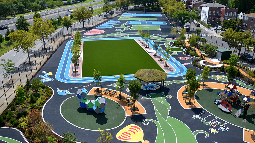 An 'after' photo of a redesigned playground in New York that now features green spaces and vibrant areas for children to play.