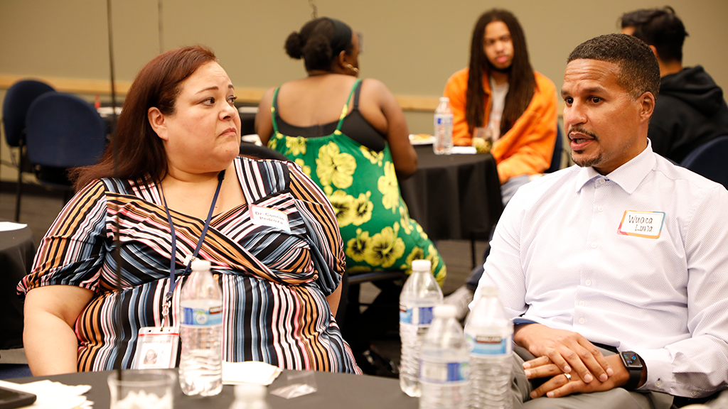 A school official and a community member participate in a Seattle Public Schools Racial Equity Engagement Meeting