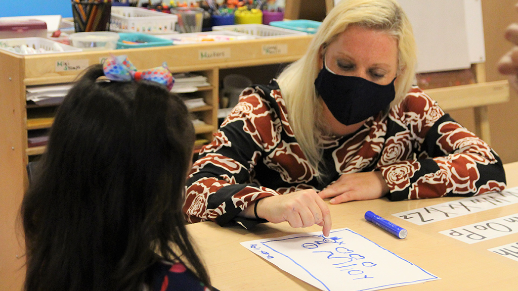 A teacher in Seattle Public Schools works with a preschool student 