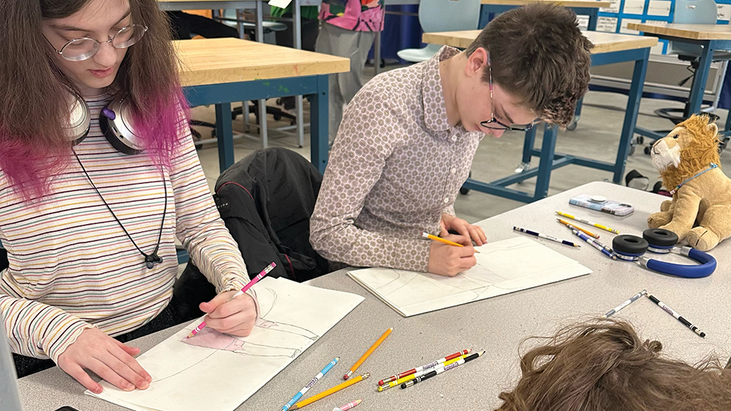 Several high school students use colored pencils and paper to draw pictures during an art therapy class. 