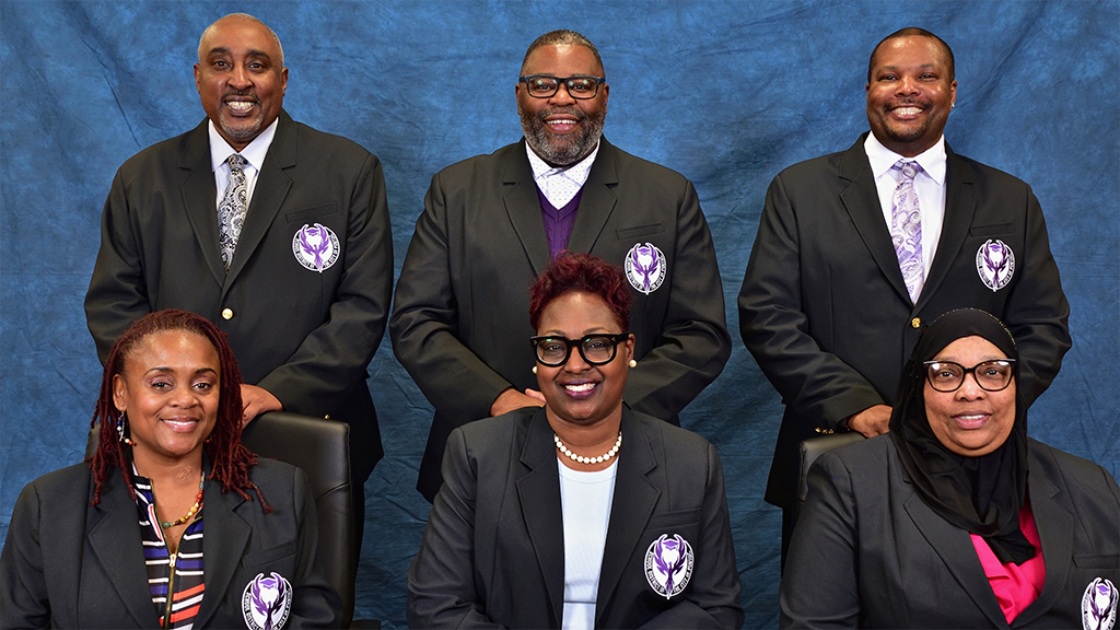 Six members of the Pontiac School District Board of Education pose for a picture. 