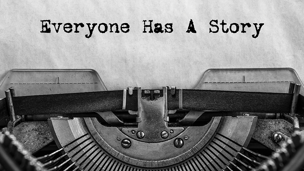 A piece of paper in a typewriter shows the words "Everyone Has A Story."
