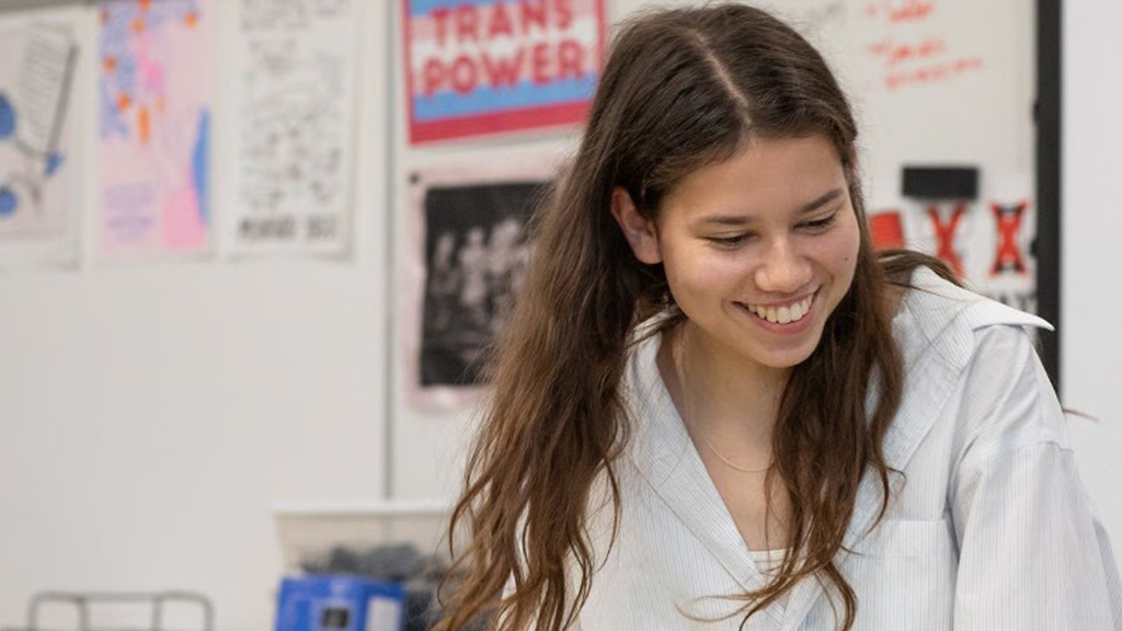 A teenage girl who is a school board representative is shown smiling. 