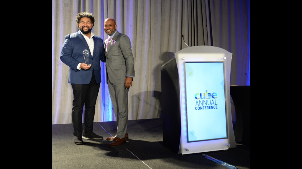 CUBE Chair Micah Ali presents the 2022 CUBE District Award to Brandon Hersey of the Seattle Public Schools school board