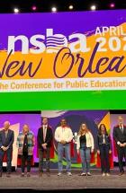 NSBA's Board of Directors wearing capes on stage at NSBA's Annual Conference