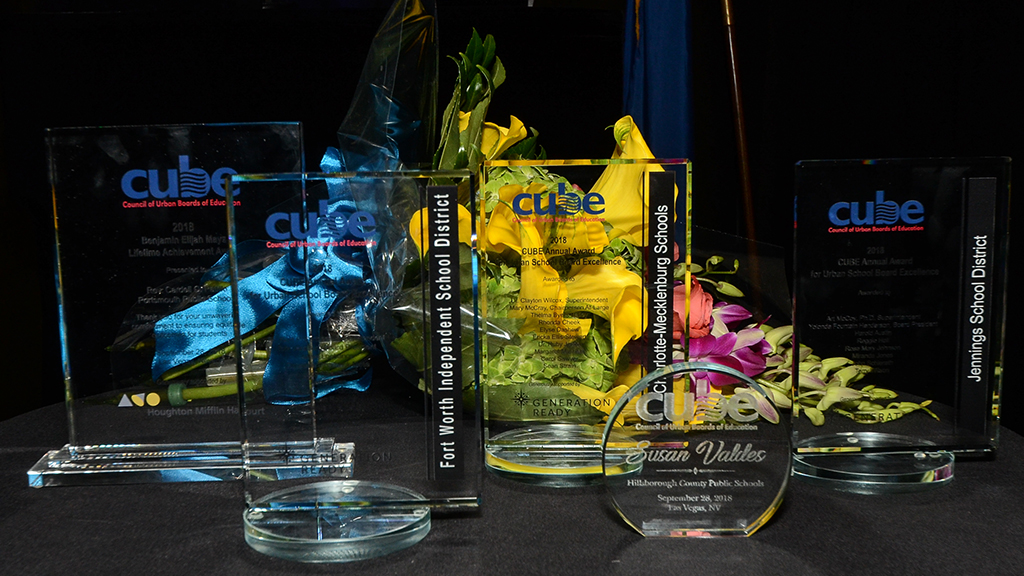 several CUBE awards on a table